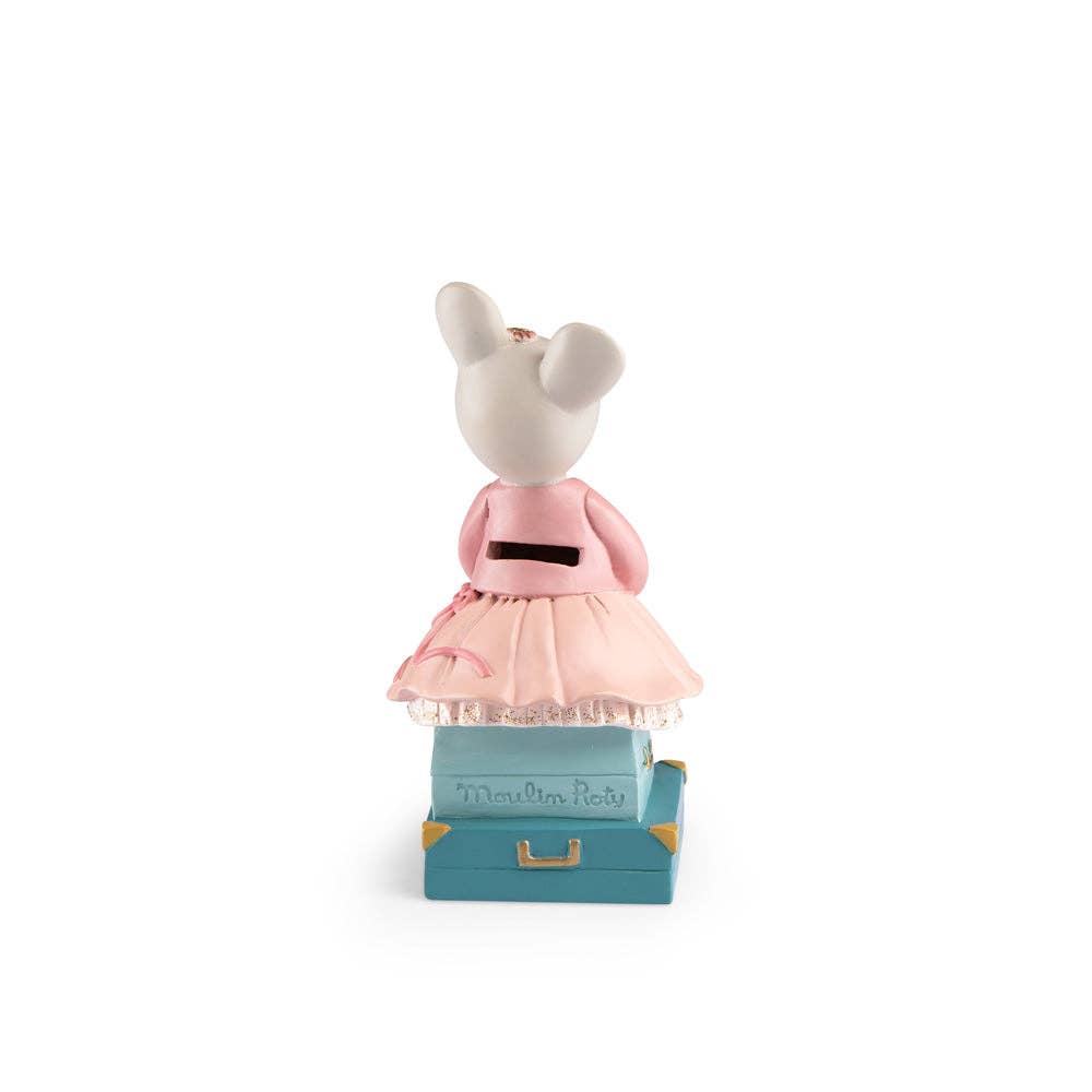 The Moulin Roty Money Box - The Little School of Dance features a plush mouse in a pink dress atop a small blue suitcase, adding charm to children's room decor as it faces away from the camera against a white background.