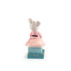 The Moulin Roty Money Box - The Little School of Dance features a plush mouse in a pink dress atop a small blue suitcase, adding charm to children's room decor as it faces away from the camera against a white background.