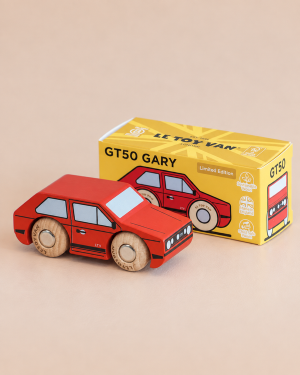 A red wooden toy car named No. 8 GT50 Gary, made in England, exudes vintage charm as it sits in front of its yellow box packaging labeled “GT50 GARY” and “Limited Edition.” With cartoon-like details and classic wooden wheels, this toy perfectly blends retro cool with playful style.