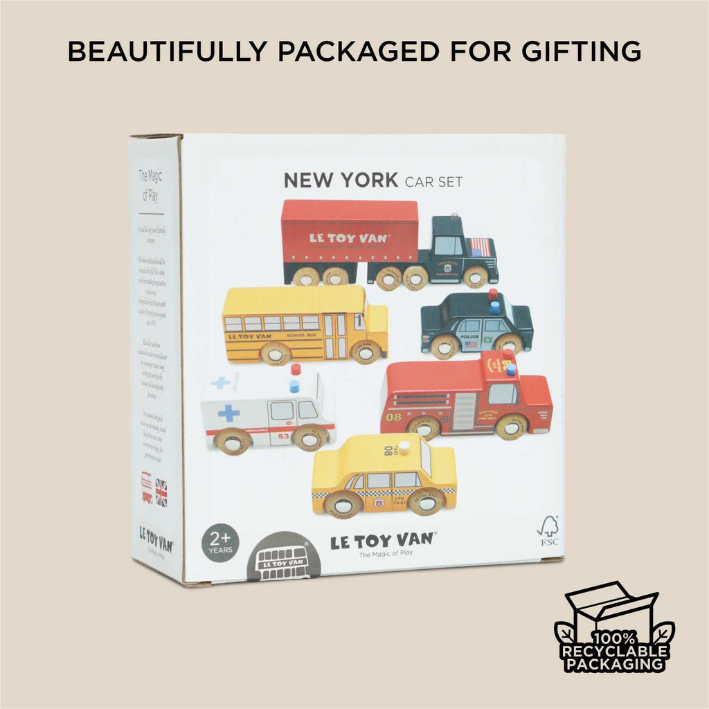 A box labeled "American Wooden Car Set" by Le Toy Van, featuring illustrations of five wooden vehicles—bus, fire truck, police car, ambulance, and taxi. Perfect for imaginative play and beautifully packaged for gifting.