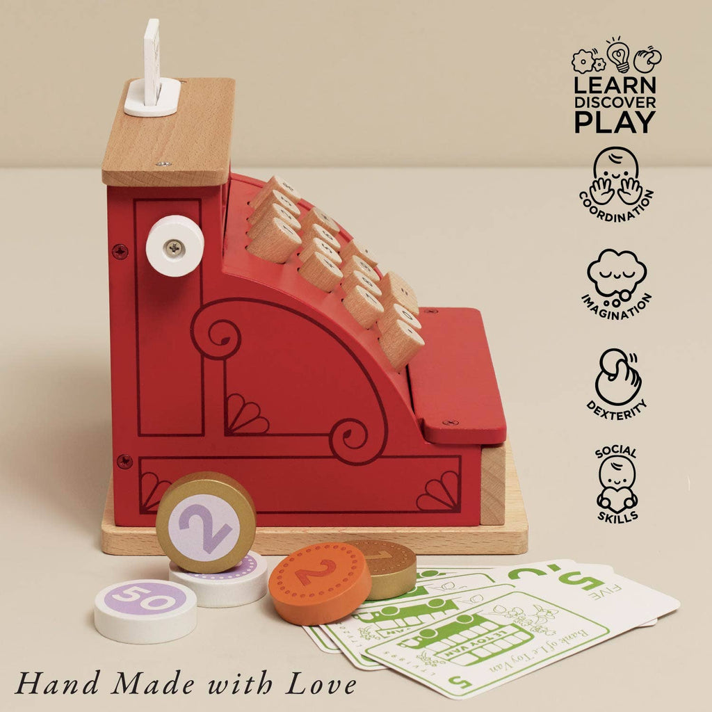 A Cash Register & Money wooden toy with colorful coins and play money sits on a beige surface. Icons highlight benefits like coordination, imagination, dexterity, and social skills. The text reads "Hand Made with Love.