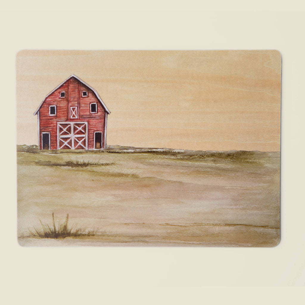 A red barn stands alone on a grassy plain under a pale sky, evoking the simplicity of the “Farm Animals Wooden Puzzle: A Tabitha Paige Puzzle” for children. Minimal vegetation surrounds it, and an empty, open landscape stretches outward—much like a scene from this toddler educational toy designed to inspire imagination and learning.