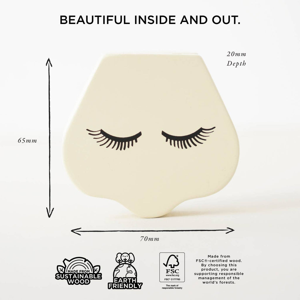 The Vanity Star Beauty Kit features a cream-colored, nose-shaped wooden makeup toy with closed eyes and long lashes, ideal for imaginative play. Measures 65x70x20mm. "Beautiful inside and out." appears above; sustainability icons shown below.