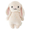 The Cuddle + Kind Baby Bunny - Confetti is a soft, hand-knit stuffed bunny toy with long, pink-accented ears, black eyes, and a sweet smile. Made from cream cotton yarn with colorful speckles—ideal for cuddling or gifting.