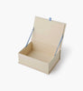 The Delphine Large Embroidered Keepsake Box, cream-colored and rectangular with a hinged lid, is open to reveal a blue ribbon and gold text on the inside lid. The keepsake box is set against a plain white background.