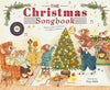 A charming illustration from "The Christmas Songbook" shows a mouse family decorating a tree and relaxing by the fireplace, surrounded by festive décor and music notes—a delightful treat for holiday carol lovers.