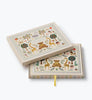 Two decorative boxes featuring enchanting illustrations of animals, trees, and books on the lids. These cream-colored boxes showcase vibrant, whimsical designs and include a yellow ribbon inside one box—perfect for storing treasured items such as your Storybook Embroidered Baby Book or other cherished keepsakes.