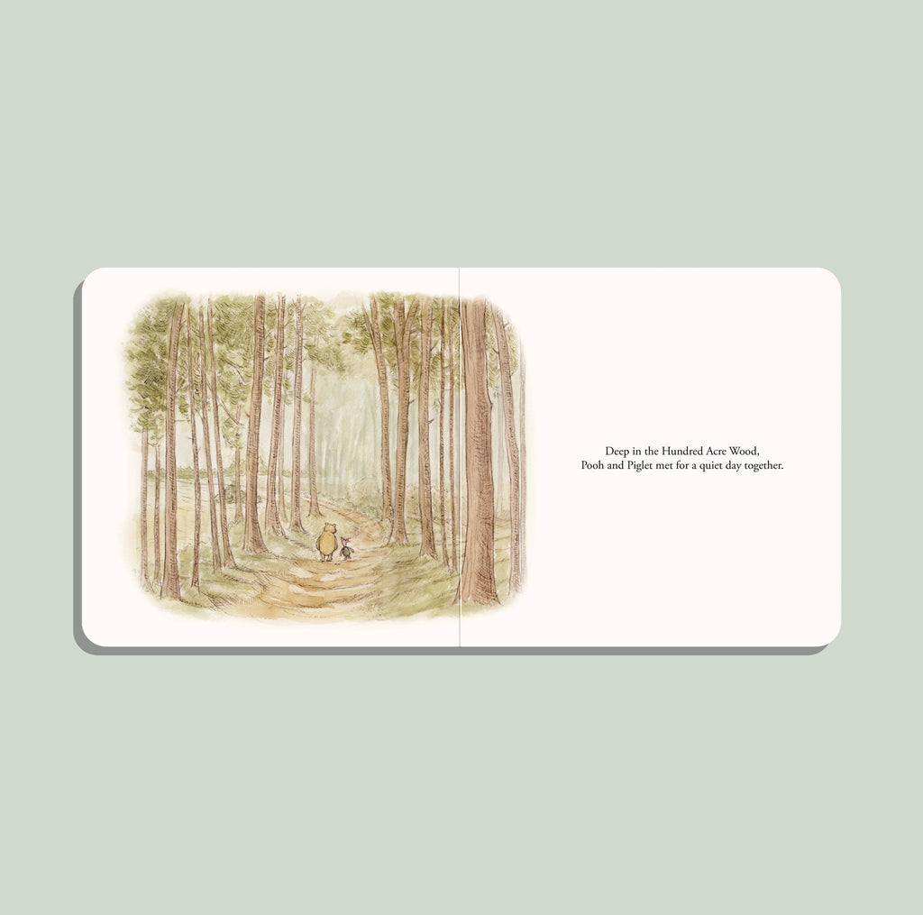 An open Winnie-the-Pooh: Finding Feelings board book by Tabitha Paige shows Pooh and Piglet walking among tall trees, sharing emotions for toddlers: “Deep in the Hundred Acre Wood, Pooh and Piglet met for a quiet day together.”.