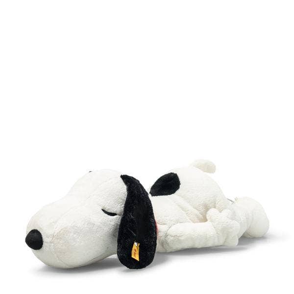 The Steiff XL Snoopy Lying Down 16" plush rests on its side with closed eyes, black ears, and a black spot on its back, displayed against a plain white background.