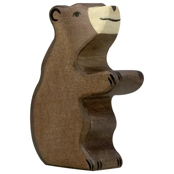 A Holztiger Little Brown Bear stands on its hind legs, handcrafted from a single piece of wood by HOLZTIGER figures. The bear is painted in brown, with lighter hues for its muzzle and snout, and detailed black markings for eyes, nose, and paws. Made in Europe with exceptional craftsmanship and detail.