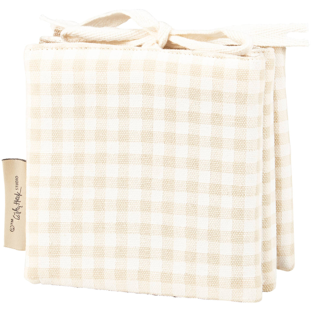 The Little Farm Soft Book features beige and white checkered, padded pages with ribbon ties—perfect as a charming infant book or thoughtful baby gift.