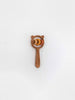 The Sabo Concept Bear and Rings Rattle in yellow and pink is a wooden rattle with a bear-shaped top, round handle, and three circular rings—perfect for boosting motor skills development on a plain white background.