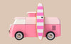 The VW Beach Bus Pink is shown in profile, featuring white accents, black wheels, and a pink-and-white striped surfboard with a small black logo mounted on the side. The background is beige.