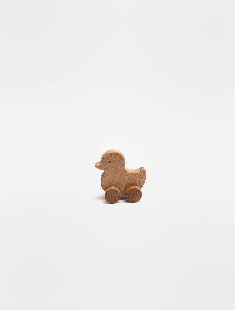 The Sabo Concept Rolling Duck - Natural, a small wooden duck toy with wheels crafted from natural materials in the SABO concept style, sits on a plain white background.