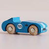 The No. 5 GT30 Coby | Made in England is a classic racing toy, featuring a blue wooden body adorned with the number 5 on its side. Its natural wood-colored wheels with text and bold white racing stripes across the hood make this car a stylish and sustainable addition to any collection.