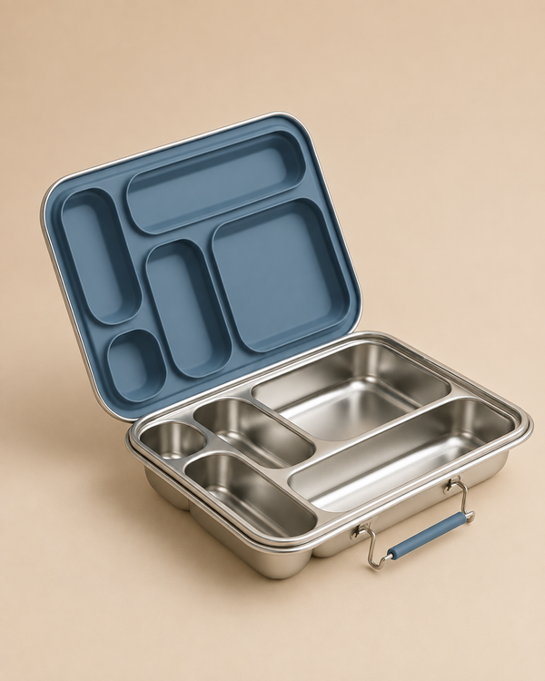 The Haps Nordic - Stainless Steel Lunch Box - Multi-Compartment (Ocean) is shown on a beige background. Featuring five spacious compartments and a blue (Ocean-colored) lid that is open and resting behind the box, it reveals well-organized interior sections and a practical blue handle. Ideal as a bento box or meal prep container, its durable stainless steel construction keeps meals fresh and neatly separated throughout the day.