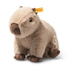 The Steiff Chip Capybara is a plush toy with soft light brown fur, dark brown nose and feet, and a yellow Steiff tag in its ear. It sits upright on a white background, exuding the trademark charm of the Chip Capybara collection.