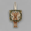 The Togetherness Deer Ornament features an embroidered deer nestled within a woodland holiday display of pine branches and baubles. It includes a loop for hanging, with a plain gray background that offers the perfect backdrop for this charming Christmas wreath.