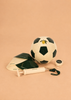 The Konges Sloejd Football Set—featuring a soccer ball, two black-and-white training cones, a stopwatch with a cord, and a hand pump—is arranged on a light brown surface, providing everything you need for the perfect backyard practice football activity.