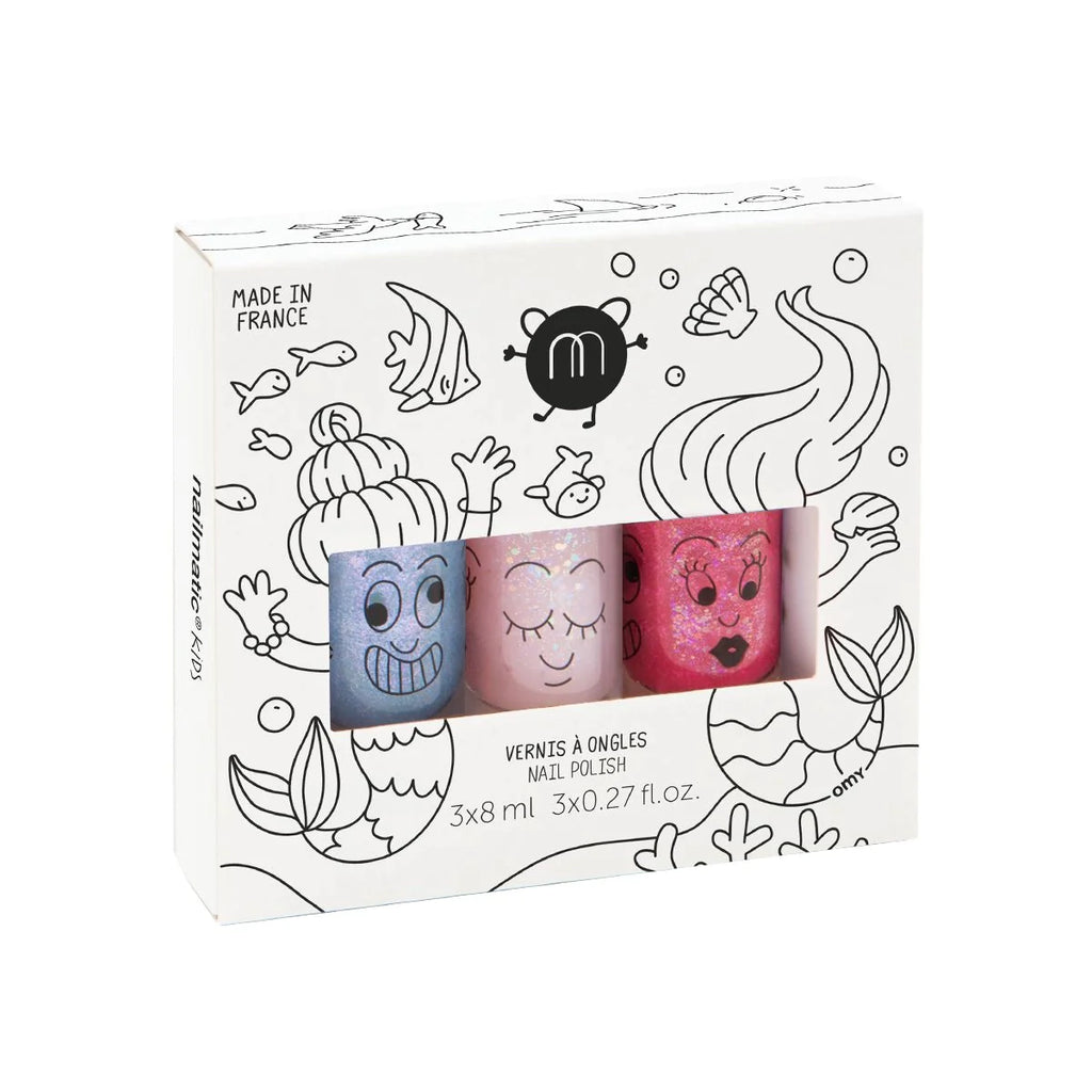 Packaging of Nailmatic - 3 Nail Polish Set - Mermaid, featuring three bottles with cartoon faces in blue, pink, and red, set against a doodle-decorated white background. Text indicates the product