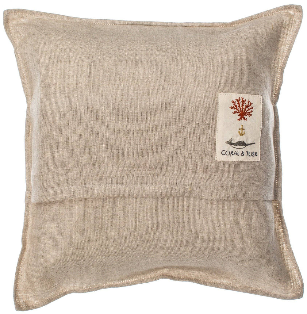 The Sailing Foxes Pillow is a square beige cushion featuring a pocket with an embroidered patch of red coral and an anchor. Perfect for decor, it includes the words "Coral & Tusk," adding nautical charm reminiscent of elegant sailboats.