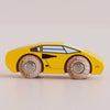 The No. 14 GT80 Lando, a yellow wooden toy car made in England, is shown in a side view on a light surface. Crafted with painted windows and details and featuring two wooden wheels, this charming racing toy offers hours of safe play with its child-safe finish.