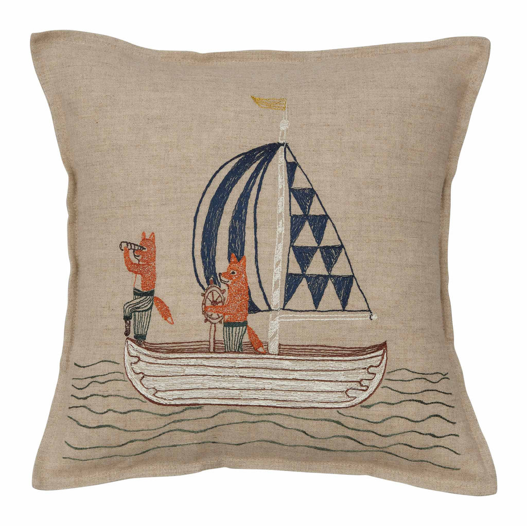 The Sailing Foxes Pillow showcases two cartoon foxes on a sailboat, one with a telescope and the other steering. The sail is adorned with blue triangles against a beige backdrop.