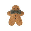 A plush gingerbread man toy with a green bow tie, featuring button eyes and a friendly smile, isolated on a black background, is now enhanced as the Donsje Wonda Gingerbread hairclip.