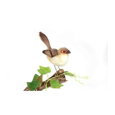 A small, hand-sewn Wren Bird Stuffed Animal perched on a twig with green leaves against a plain white background. The bird has a light brown and white body with a long tail.