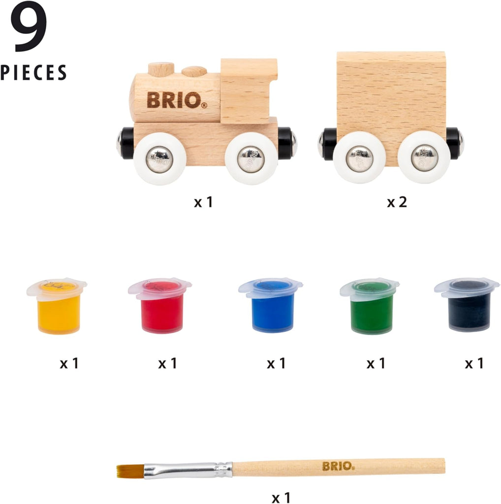 The BRIO World Paint Train set includes a wooden train, wagon, 5 small paint pots (yellow, red, blue, green, black), and a paintbrush on a white background. “9 pieces” text above. Let kids create their own colorful train masterpiece!.