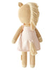 Cuddle + Kind Kelsie the Pony is a hand-knit, fair trade plush toy featuring light brown yarn skin, cream hooves, cream mane and tail, and a light pink dress. The doll is shown from the back.