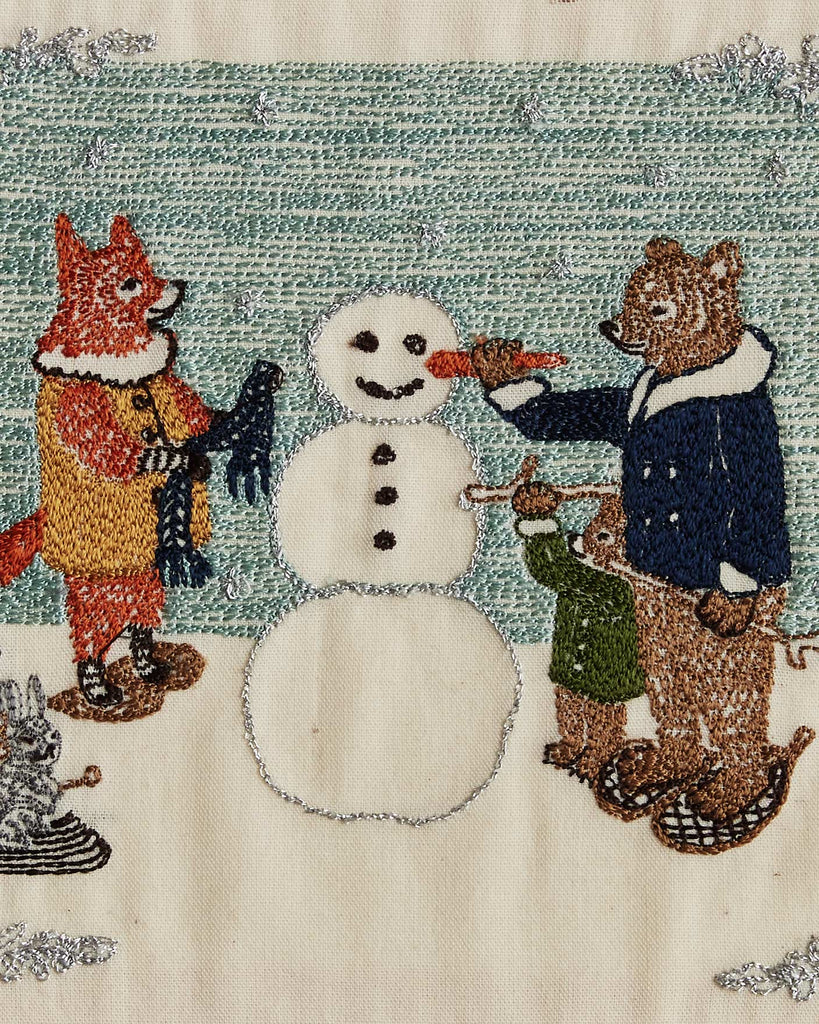 The Coral & Tusk Snowman Card features embroidered animals— a fox with a scarf and a bear with cub placing a carrot nose on the snowman— set against falling snow, making it an enchanting choice for winter décor.
