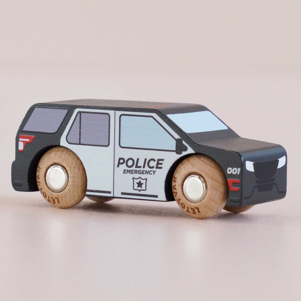 Introducing the No. 42 GT260 Liberty, a small wooden police SUV made in England. Crafted in classic American style, it features black and white detailing, sturdy wooden wheels, and the word “POLICE” printed on the side—perfect for imaginative storytelling adventures.