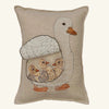 The Coral & Tusk Mama Duck Pocket Pillow in beige features an embroidered white duck and three removable felt ducklings in neutral tones, all nestled under its wing on a plain background.