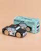 A classic toy, the No. 41 GT255 Sam wooden police car with painted details is displayed in front of its matching limited edition box labeled “Made in England,” both set on a light brown surface—perfect for imaginative play.