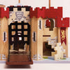 The Lionheart Wooden Castle is crafted from sustainable wood and features a red roof, open drawbridge, and decorative shield and lion banners—all accented with stone patterns and arched windows—making it perfect for inspiring imaginative play.