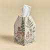 An embroidered Coral & Tusk Mushrooms and Ferns tissue box cover designed to look like a house, featuring woodland scenes with a deer, mushrooms, and ferns on a beige background.