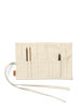 The Ferm Living Ally Pencil Wrap in off-white, made from organic cotton with multiple pockets, is shown partially open on a white background holding two pencils and a black sharpener.