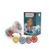 The Moulin Roty Storybook Lantern - The Minouchkas is a children’s projector toy with a red handle, five story reels, and a decorative box featuring an illustrated bear under the night sky—a magical bedtime storyteller.