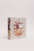 The Beneath the Branches 200 Piece Puzzle features a whimsical treehouse scene with animals and people, soft pastel packaging, and matte, recycled pieces. Perfect for ages 7+, it promises eco-friendly fun.