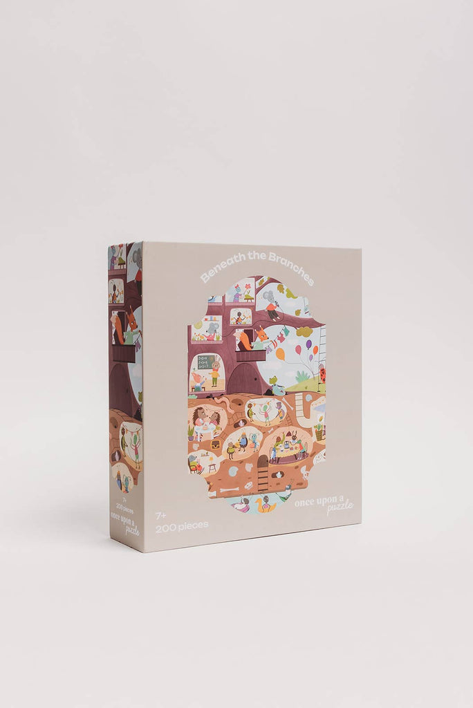 The Beneath the Branches 200 Piece Puzzle features a whimsical treehouse scene with animals and people, soft pastel packaging, and matte, recycled pieces. Perfect for ages 7+, it promises eco-friendly fun.