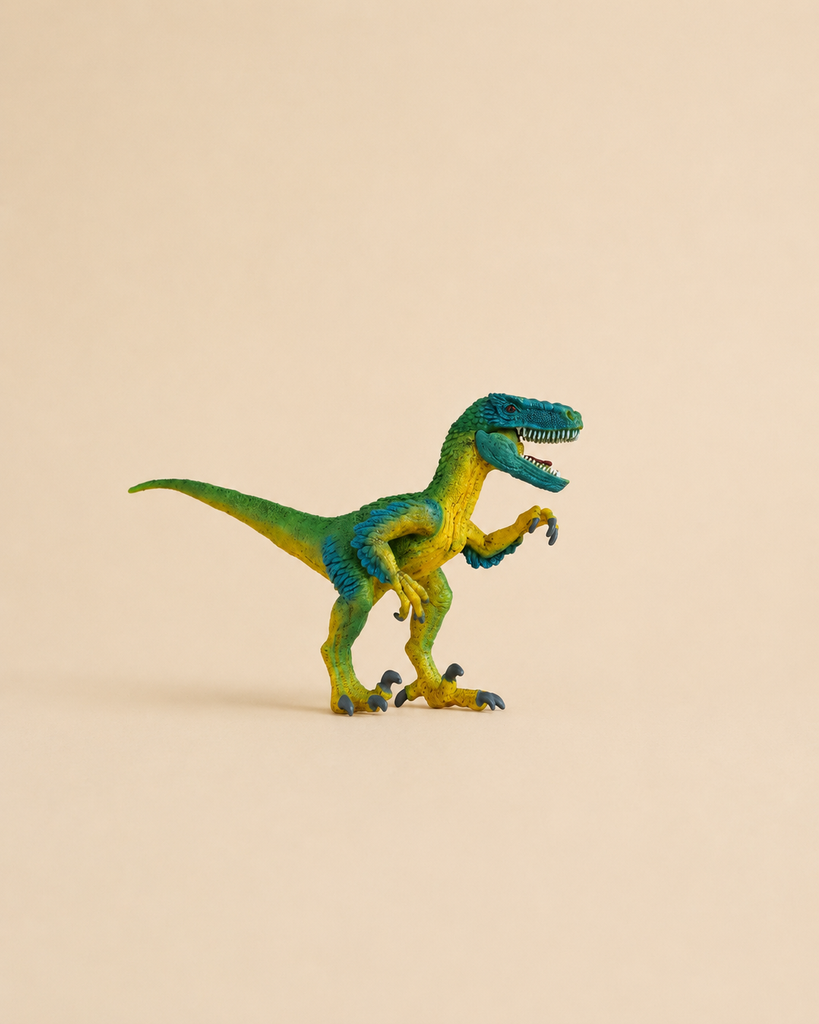 A small Schleich Velociraptor Dinosaur Toy, featuring green and blue markings, stands on a beige background with its mouth open and claws raised. This educational dinosaur figurine showcases lifelike details, making it perfect for imaginative play or display.