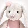 The Steiff Hoppie Rabbit Ballet is a plush bunny with long floppy ears, black button eyes, a pink heart nose, a soft white face, a light pink tutu-like dress, and a pink fabric flower by one ear.