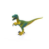 The Schleich Velociraptor Dinosaur Toy, featuring green coloring with yellow detailing, stands on two legs with its mouth open and claws raised, isolated on a white background—an educational toy perfect for young explorers.