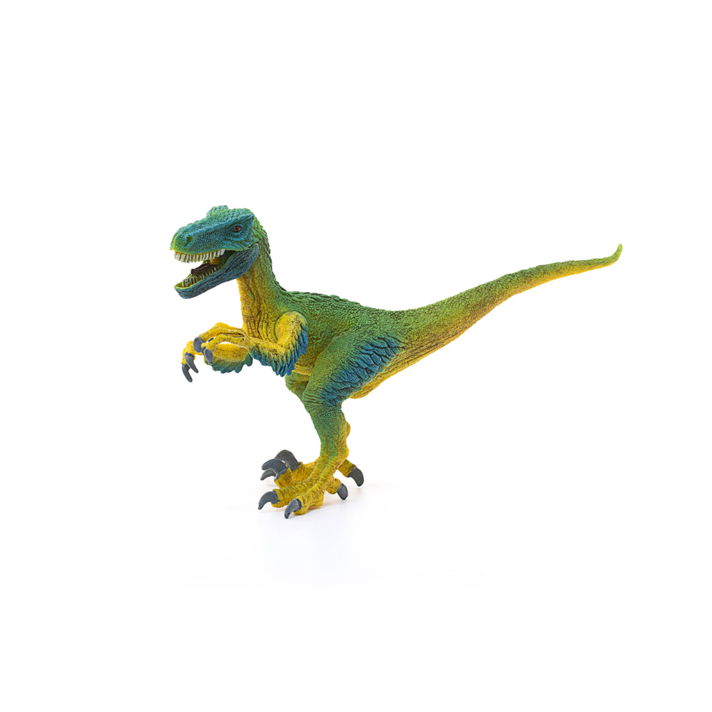 The Schleich Velociraptor Dinosaur Toy, featuring green coloring with yellow detailing, stands on two legs with its mouth open and claws raised, isolated on a white background—an educational toy perfect for young explorers.