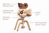 The Father’s Factory | Super 16 Pro Wooden Toy Camera with Tripod features labeled parts—spinning rewind lever, kaleidoscope viewfinder, spinning shutter, swivel lens—and a self-assemble tripod. Crafted from light and dark wood for added style.