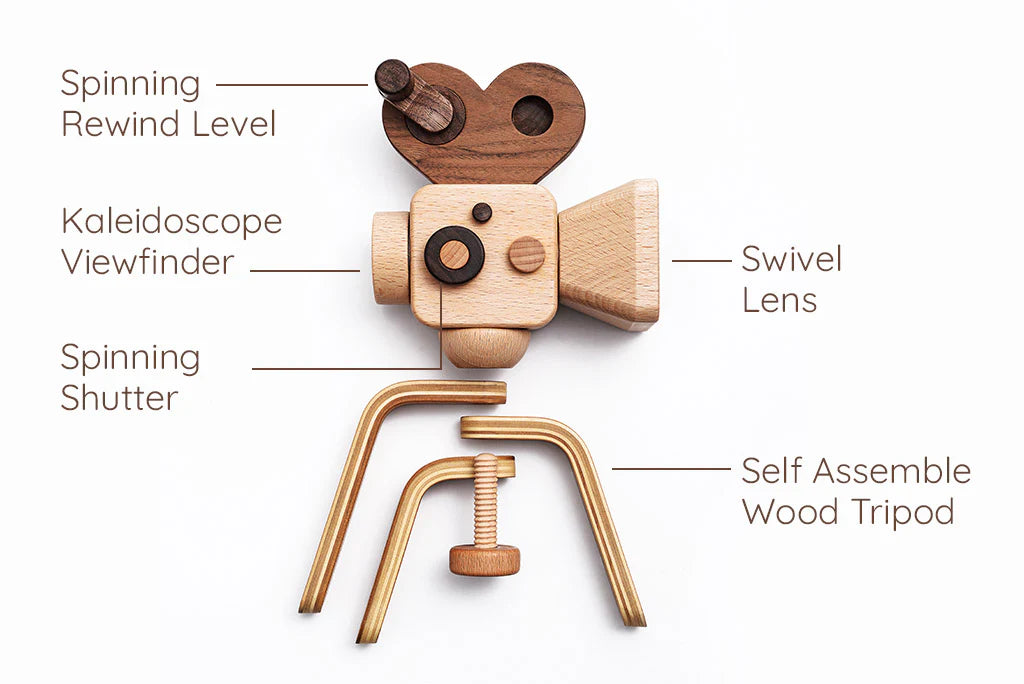 The Father’s Factory | Super 16 Pro Wooden Toy Camera with Tripod features labeled parts—spinning rewind lever, kaleidoscope viewfinder, spinning shutter, swivel lens—and a self-assemble tripod. Crafted from light and dark wood for added style.