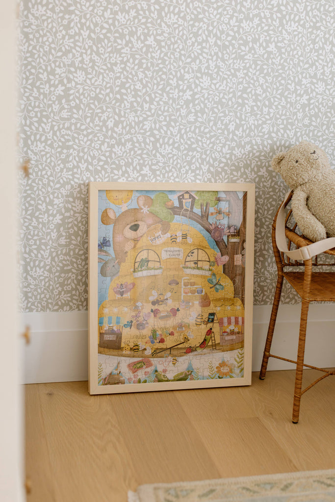 The Honeycomb Cafe 200 Piece Puzzle features whimsical animal illustrations on matte, textured pieces made from recycled materials—perfect for leaning against floral wallpaper or displaying near a cozy chair with your favorite teddy bear.