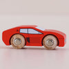The No. 25 GT140 Marco, a small red wooden racing car toy featuring black window and detail markings with natural wood wheels, is shown on a light surface. Made in England.