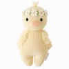 Hand-knit from Peruvian cotton yarn, the Cuddle + Kind Baby Duckling (Ivory Floral Crown) features a peach beak, black eyes, ivory flower crown, fluffy wings, and a light blue tag—an heirloom-quality plush for any collection.